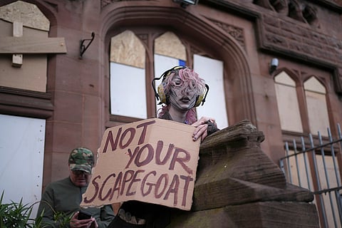 A counter protestors holds a placard